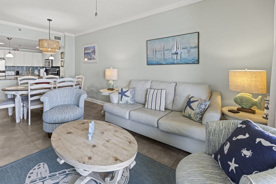 Relax in your coastal-inspired living space with plush seating, nautical touches, and an open layout that flows to your dining and kitchen areas.