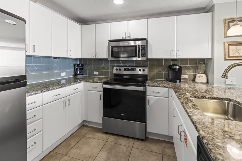 Your fully equipped kitchen features granite counters, stainless appliances, and everything needed to create delicious meals during your stay.