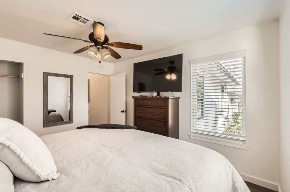 Peaceful bedroom with a plush queen-sized bed and soft linens for a restful night’s sleep.
