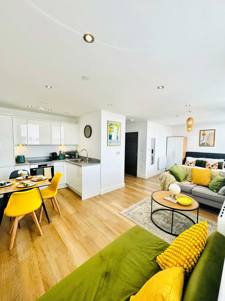 Open-plan living and kitchen space with modern furnishings, perfect for socialising and relaxing together