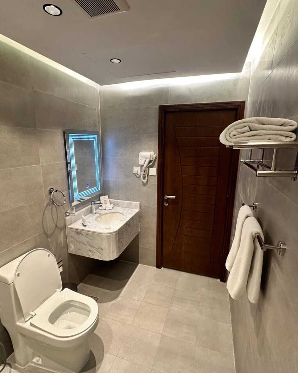 Deluxe Room | Bathroom | Hair dryer, slippers, towels, soap