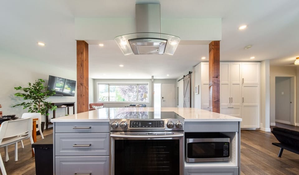 Cook up a feast in this modern, fully-equipped kitchen. Featuring stainless steel appliances and a large kitchen island, it`s the perfect hub for gathering with friends and family