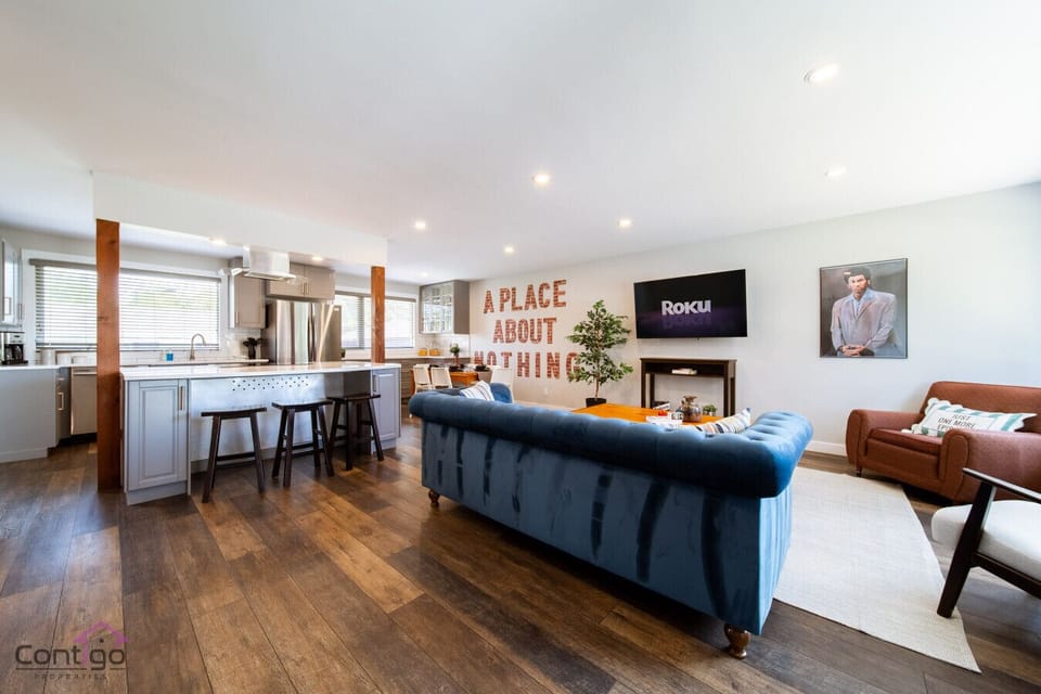 Gather in the open-concept living area with plush seating, and fully equipped kitchen, designed for comfort and connection.