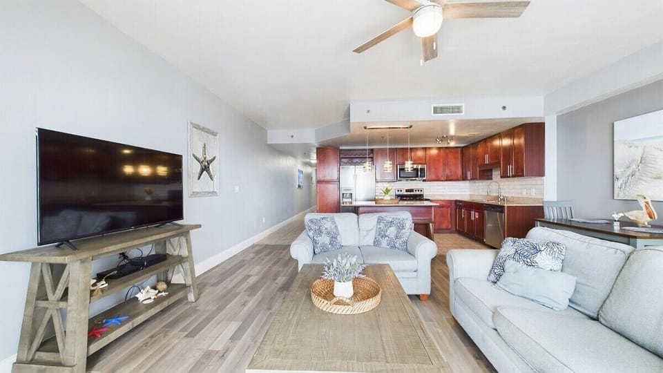 Open concept living area with TV coastal views and sleeper sofa