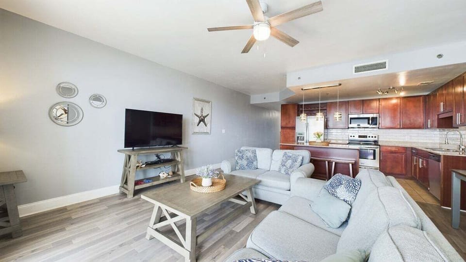 Open concept living area with TV coastal views and sleeper sofa