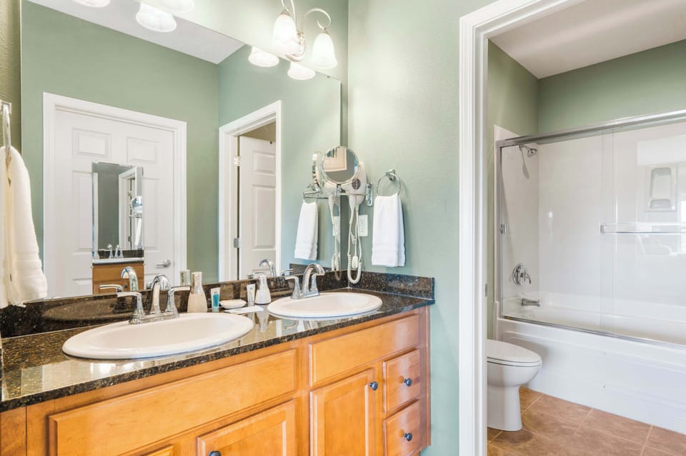 Wash up in this king ensuite, featuring a double vanity & shower/tub combo
