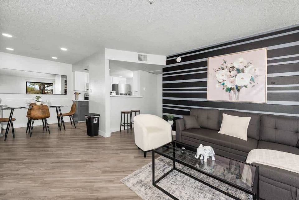 Modern living room, dedicated working space, TV, plush couch, and sofa bed