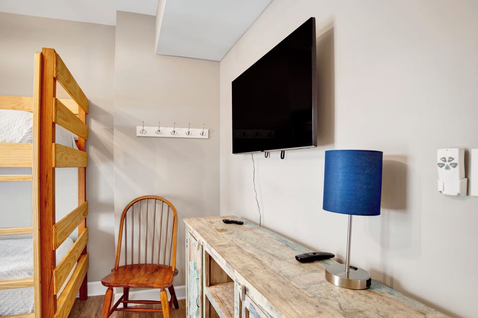 1st floor bunk bedroom has a TV and shares the hallway bathroom
