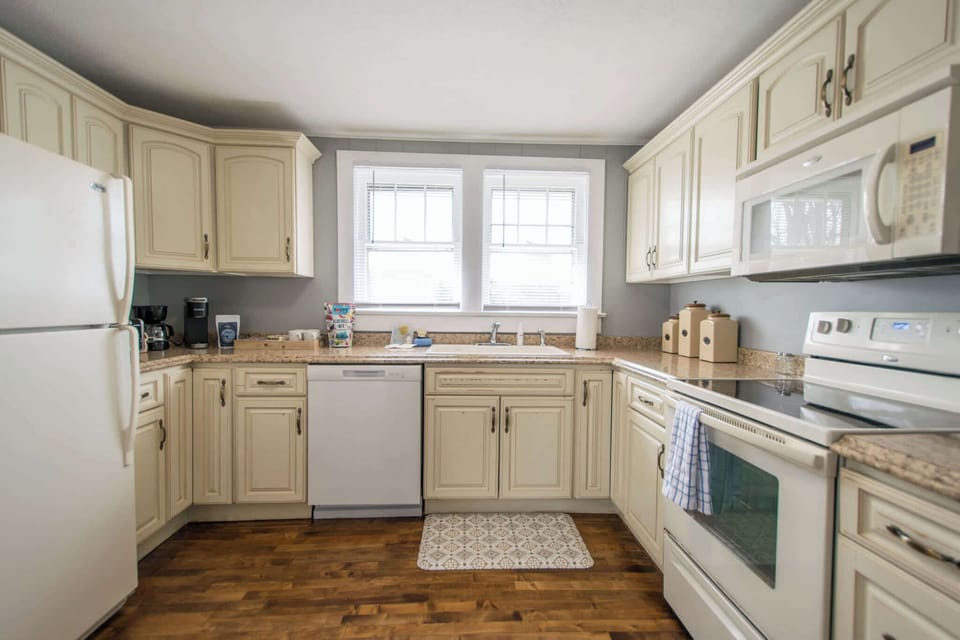 Kitchen stocked with pots and pans, utensils, cooking essentials.
