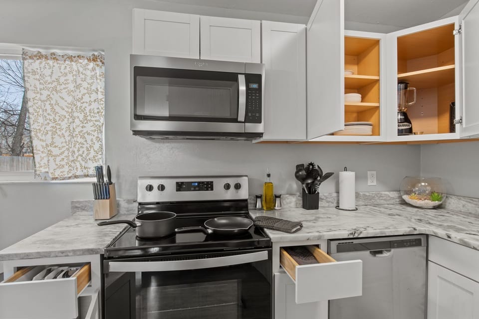 fully stocked kitchen with pots and pants