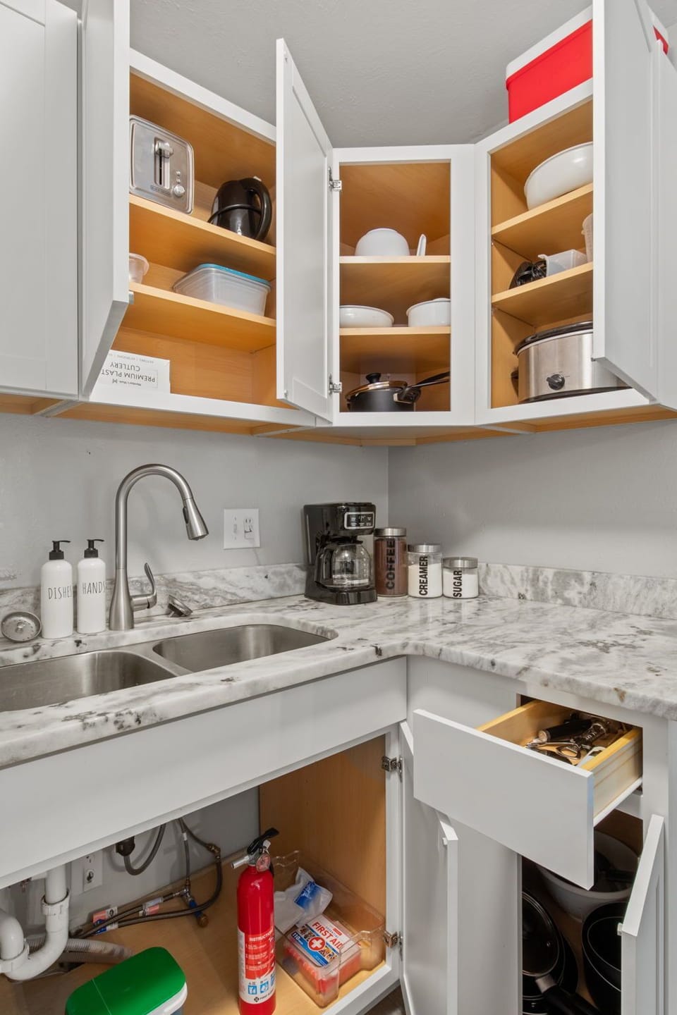 kitchen with blender, toaster, crock pot, pots, pans, coffee maker