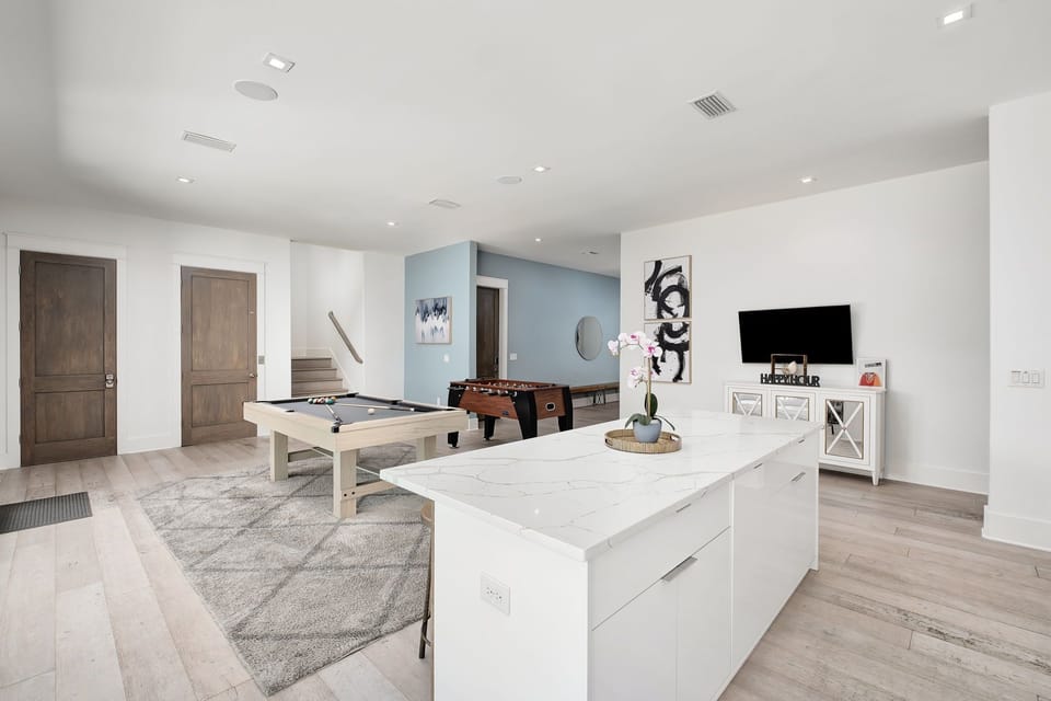The game room also includes a kitchenette and flat-screen TV.