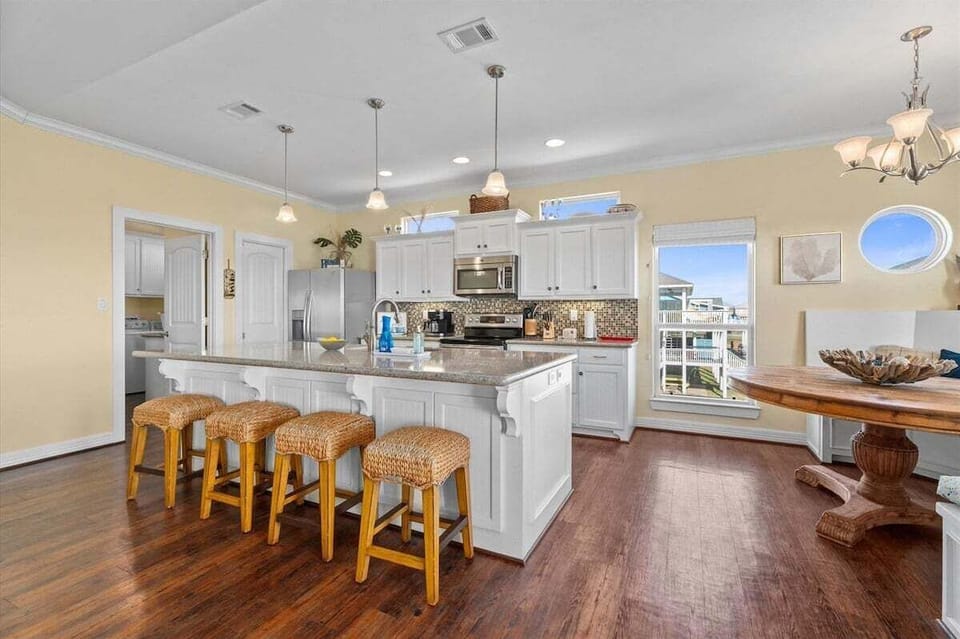 Bright gourmet kitchen with large island, bar seating, and modern finishes in this Crystal Beach vacation rental near the Texas Gulf Coast.