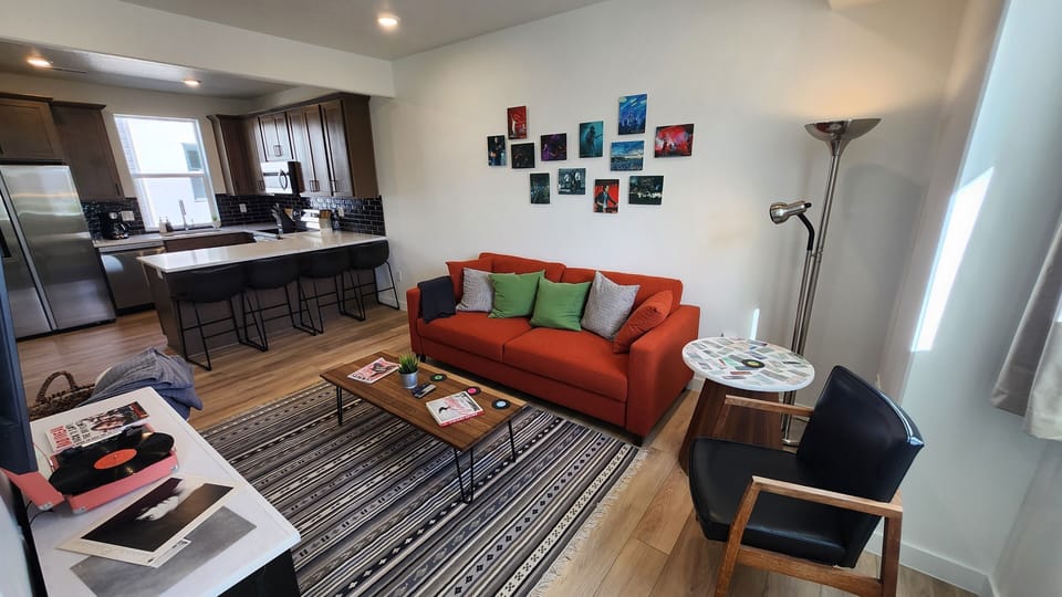 Living Room w/queen sofa sleeper, 55” smart TV, record player, books and games.