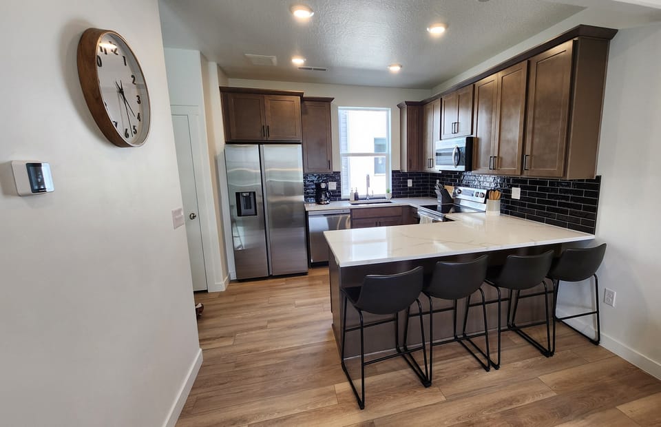 Full kitchen w/fridge, oven/stove, dishwasher, pots, pans, dishes and utensils.