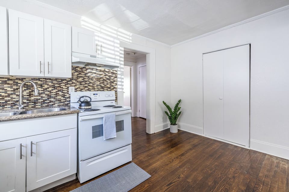 Indulge in pure bliss in this kitchen! Clean lines and a bright white color palette create a feeling of spaciousness and tranquility. So much potential!