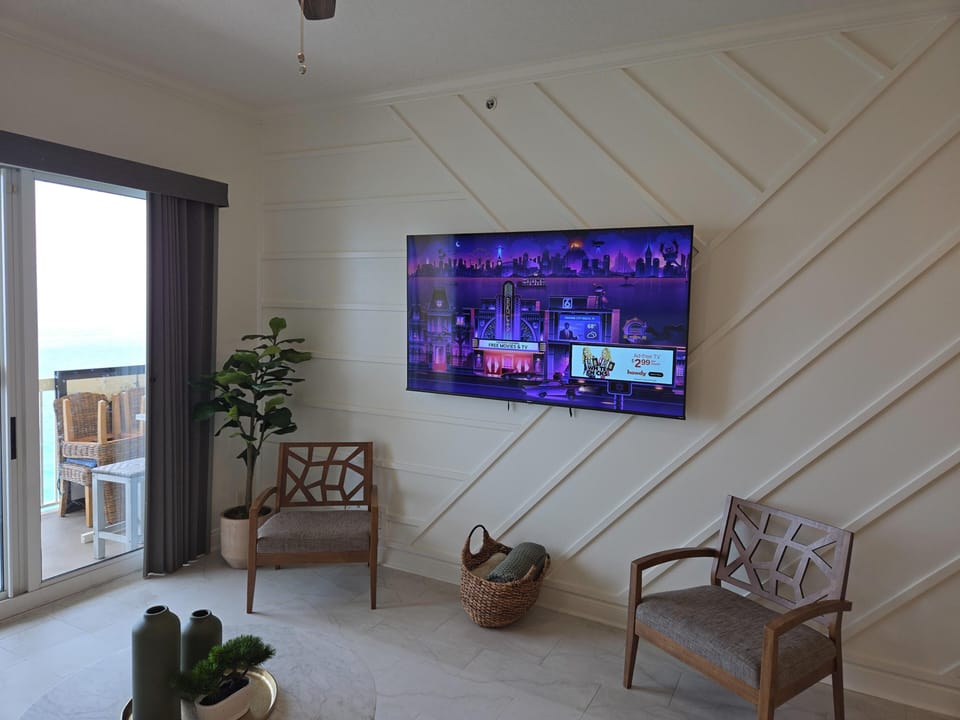 Cozy living room with stylish seating and vibrant TV setup