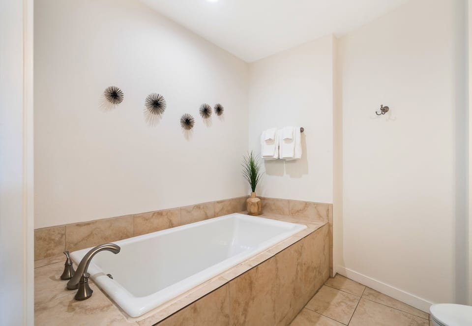 Sink into the deep soaking tub and let your worries melt away.