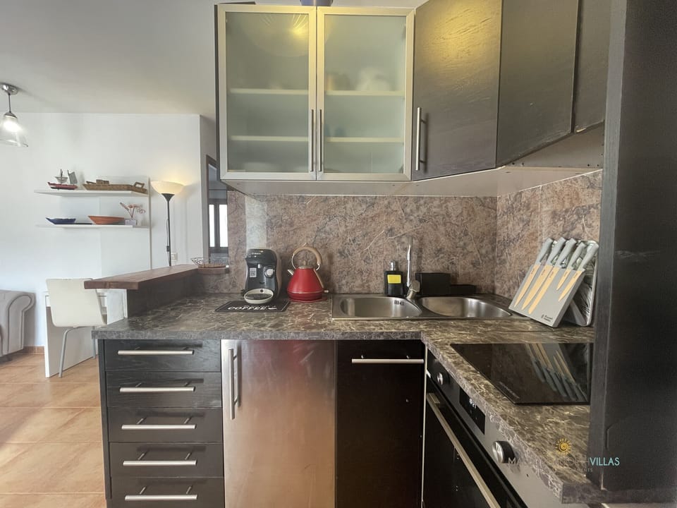 Modern kitchen with countertop, sink and coffee maker