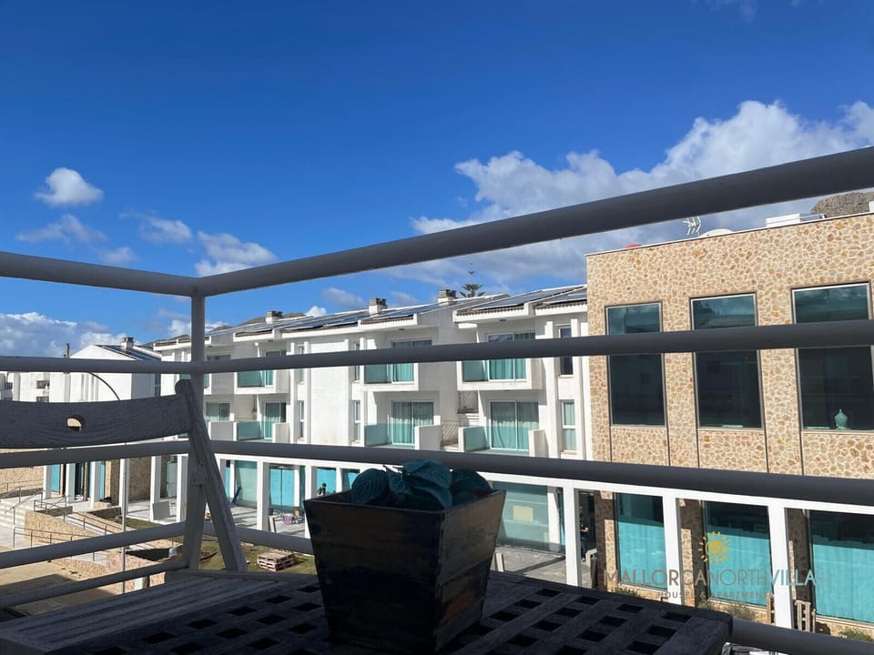 Balcony with open views over a modern residential complex, ideal for enjoying fresh air and natural light in this Puerto Pollensa apartment.