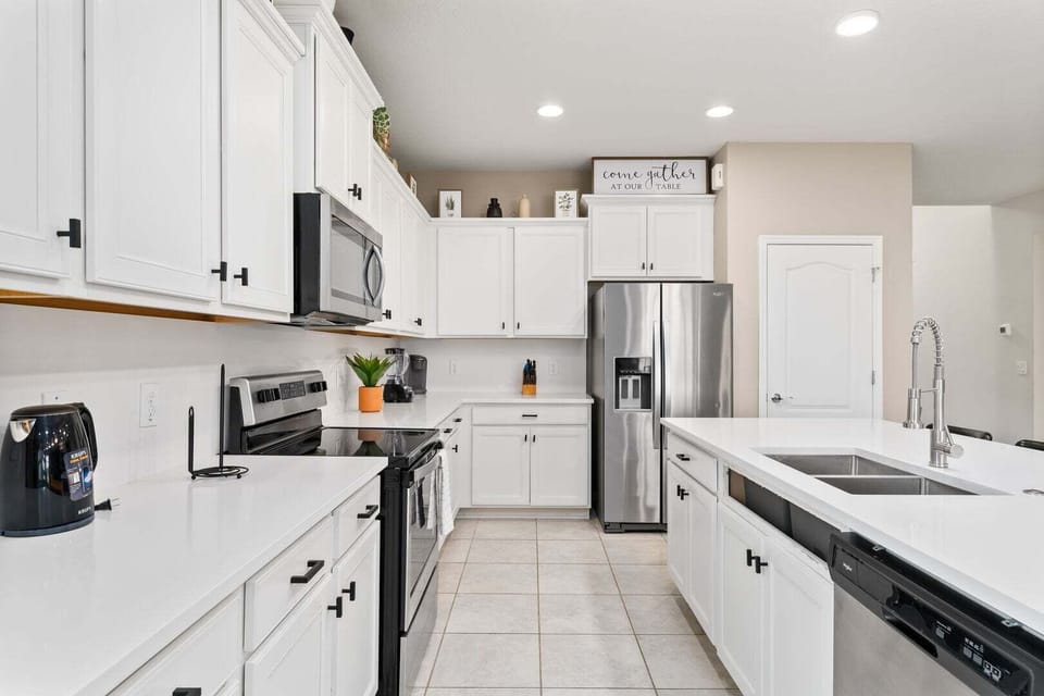 Fully equipped kitchens with stainless steel appliances.