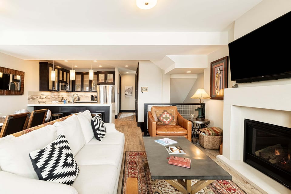 Living Room with Samsung smart tv, comfy furniture, gas fireplace, and small work area