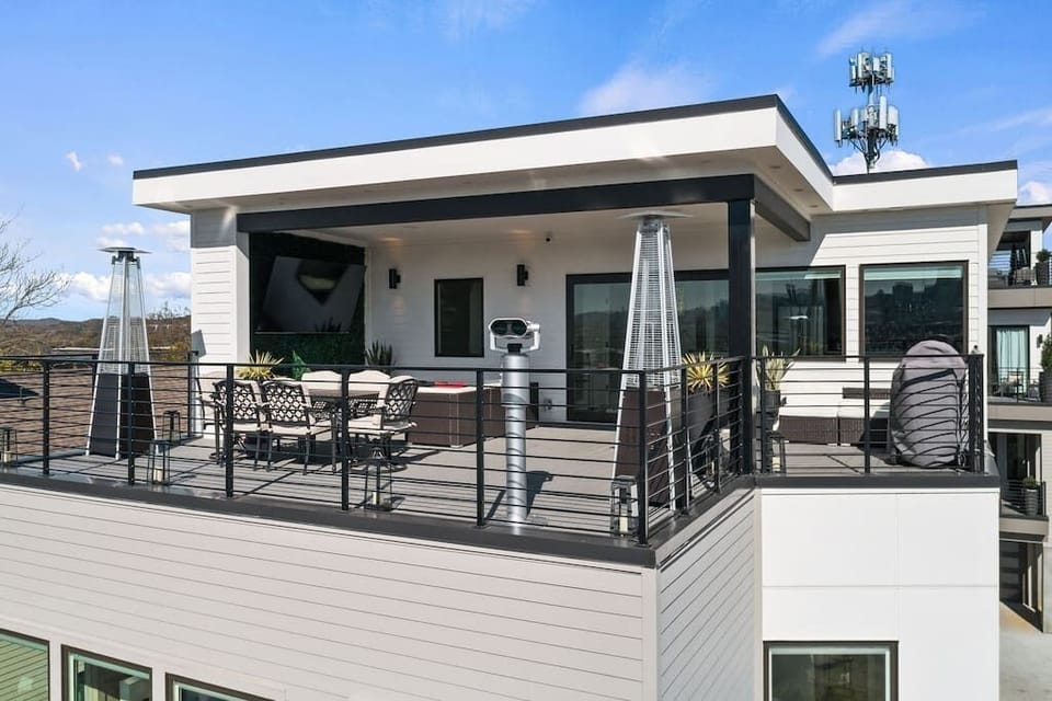 Rooftop floor has a full bath, elevator access, kitchenette, daybed with pullout trundle bed (sized XL twin).

4th floor outdoor roof-deck is half covered with an 85" flatscreen TV, fire pit, 2 heaters, electric smoker, dining room, & view finder.