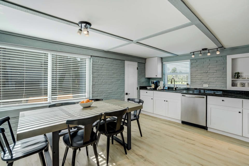 A bright and inviting kitchen and dining area with modern finishes, plenty of natural light, and everything you need for a home-cooked meal.