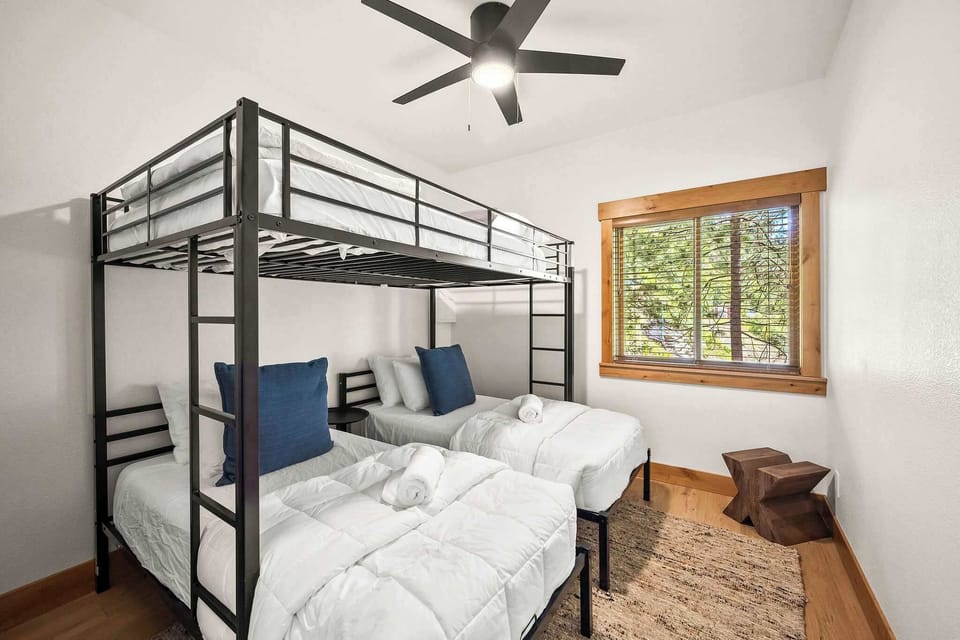 Drift off in crisp white linens while the ceiling fan keeps you cool. Natural light filters through your private window.
