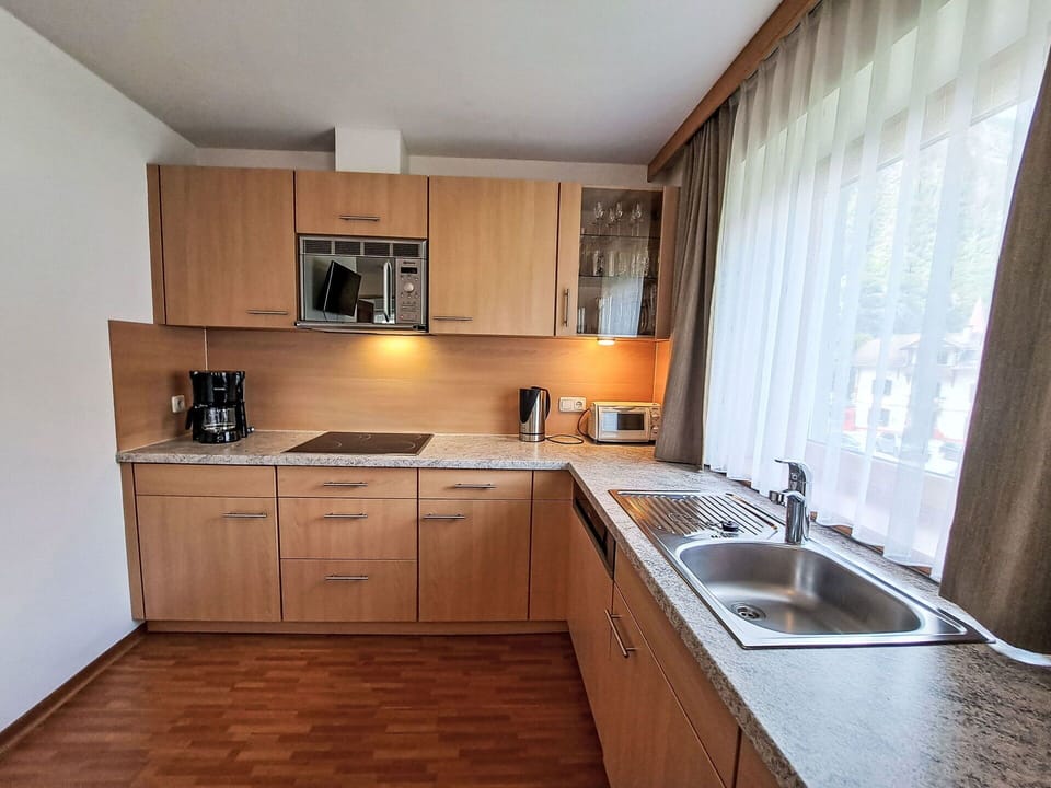 Furniture, Interior Design, Wood, Countertop, Flooring, Kitchen, Cabinetry, Floor, Room, Kitchen Sink