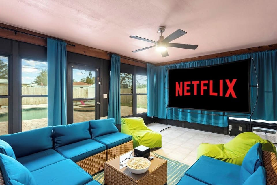 Enclosed theater room with smart projector, blackout curtains, and air conditioning - ideal for family movie nights and group entertainment for watching the big game.