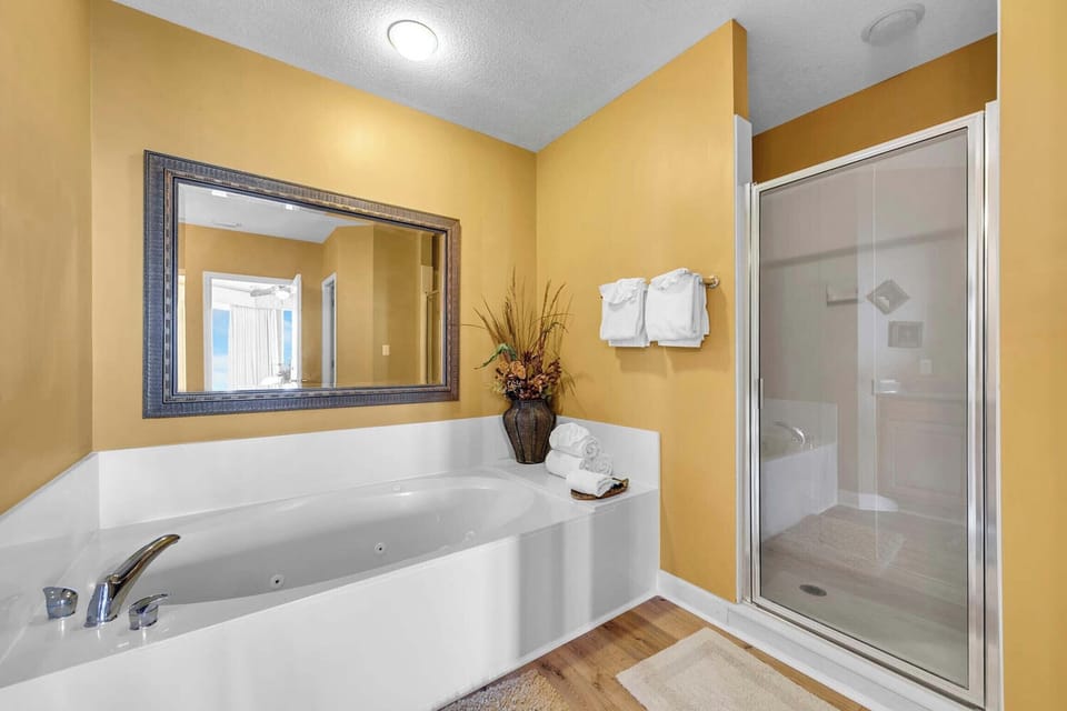 There is a large garden tub and a walk-in shower