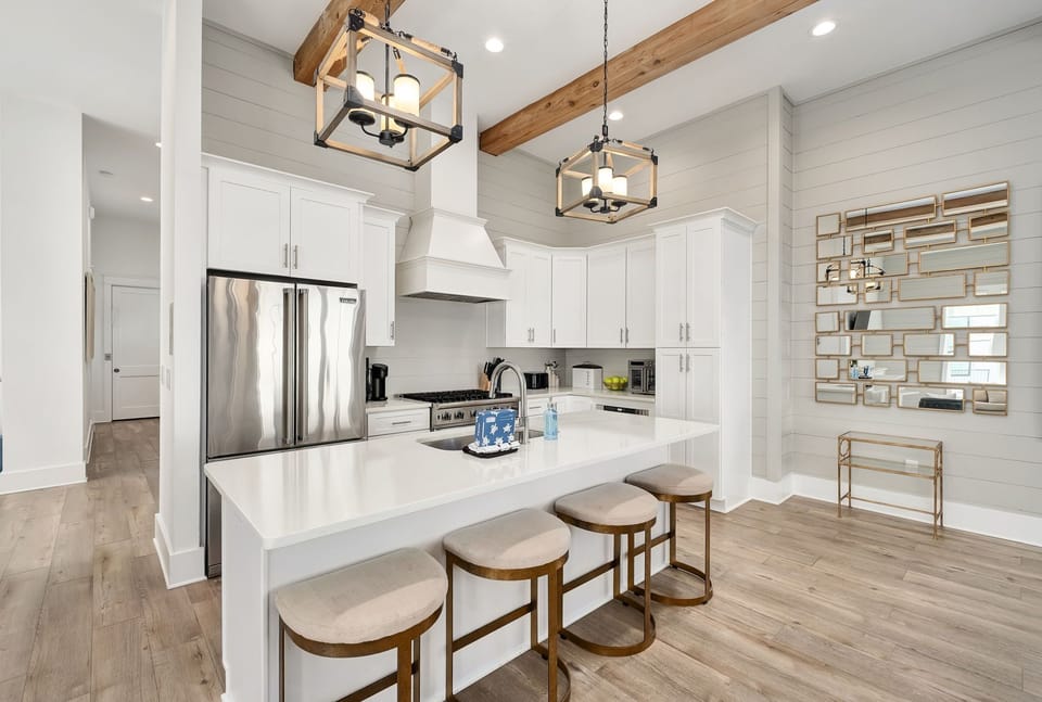 Gather around the refined chef’s kitchen with soaring ceilings and a spacious island.