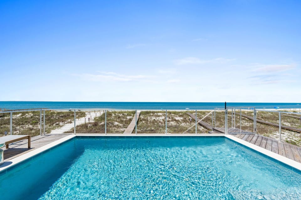 Private pool with direct beach access and stunning turquoise waters—your perfect coastal escape awaits just steps from pristine white sands.