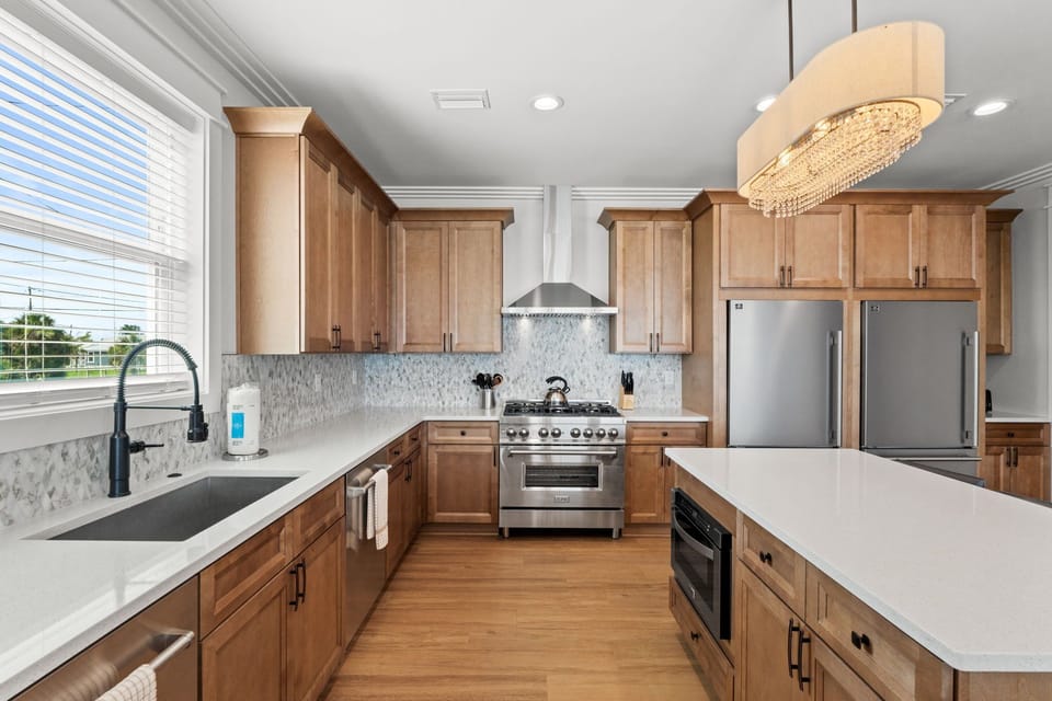 Your gourmet kitchen awaits with spacious countertops, modern appliances, and warm wood cabinetry—perfect for preparing meals and gathering with loved ones in style.