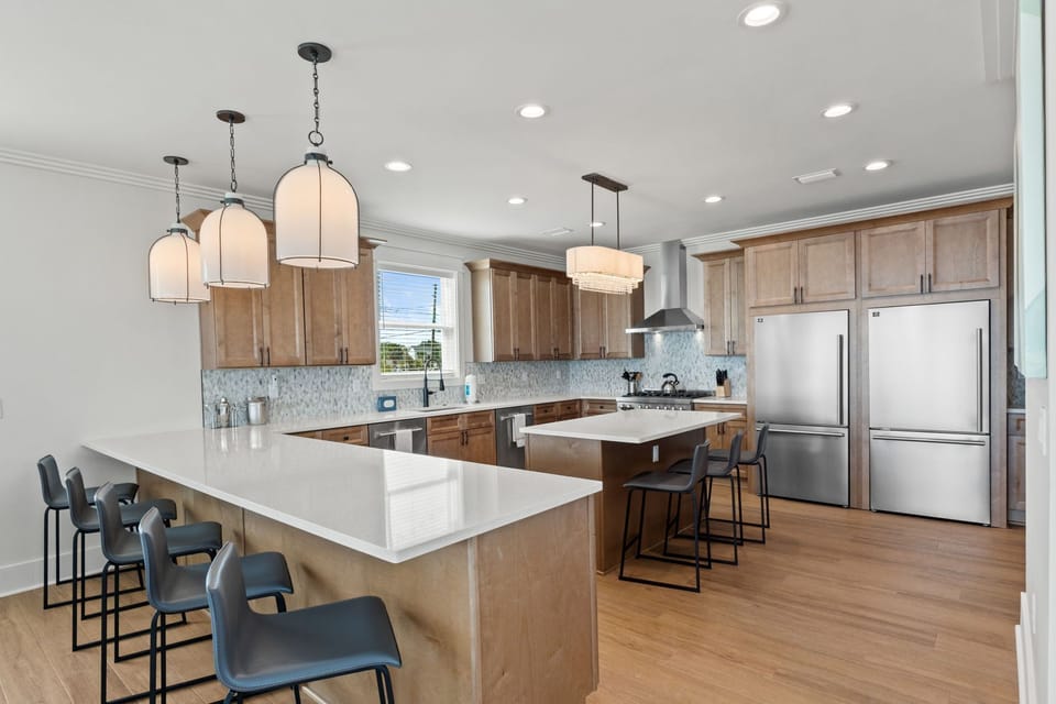 Your spacious kitchen boasts gleaming quartz countertops, modern appliances, and warm wood cabinetry—perfect for cooking up vacation meals together.