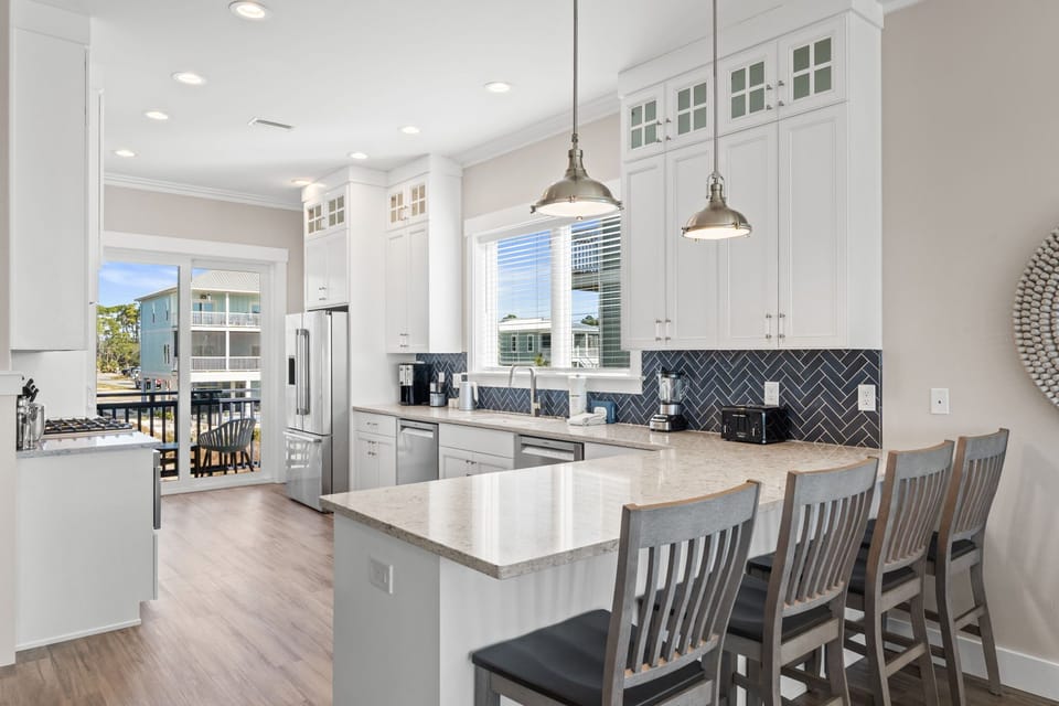 Your gourmet kitchen awaits with gleaming quartz countertops, modern appliances, and a spacious island perfect for morning coffee or evening cocktails.