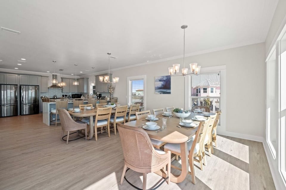 Gather around this elegant dining space where warm wood tones meet coastal style, perfect for memorable meals with your group.