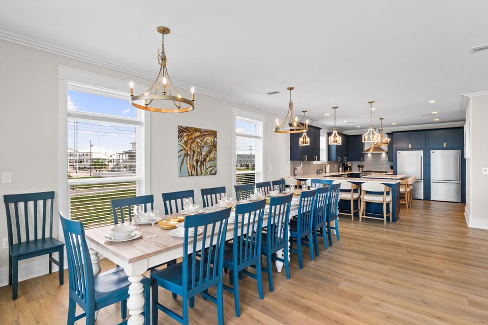 Spacious open-concept dining and kitchen area perfect for gathering your entire group. The farmhouse-style table seats everyone comfortably, while the modern kitchen invites shared meal prep and conversation.