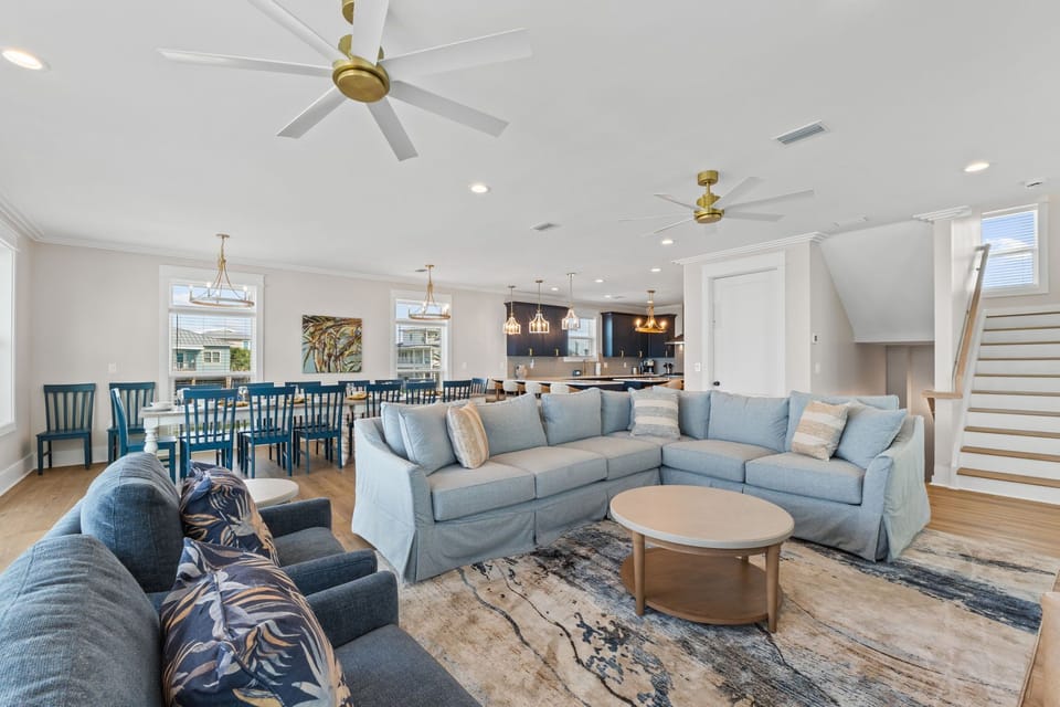 Spread out in your airy, open-concept living space where natural light and coastal colors blend with cozy seating and a dining table that seats the whole crew.