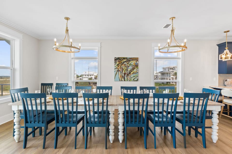 Gather your whole group around this stunning farmhouse dining table, where coastal charm meets everyday comfort. Natural light pours in through generous windows, setting the perfect scene for shared meals and lasting memories.