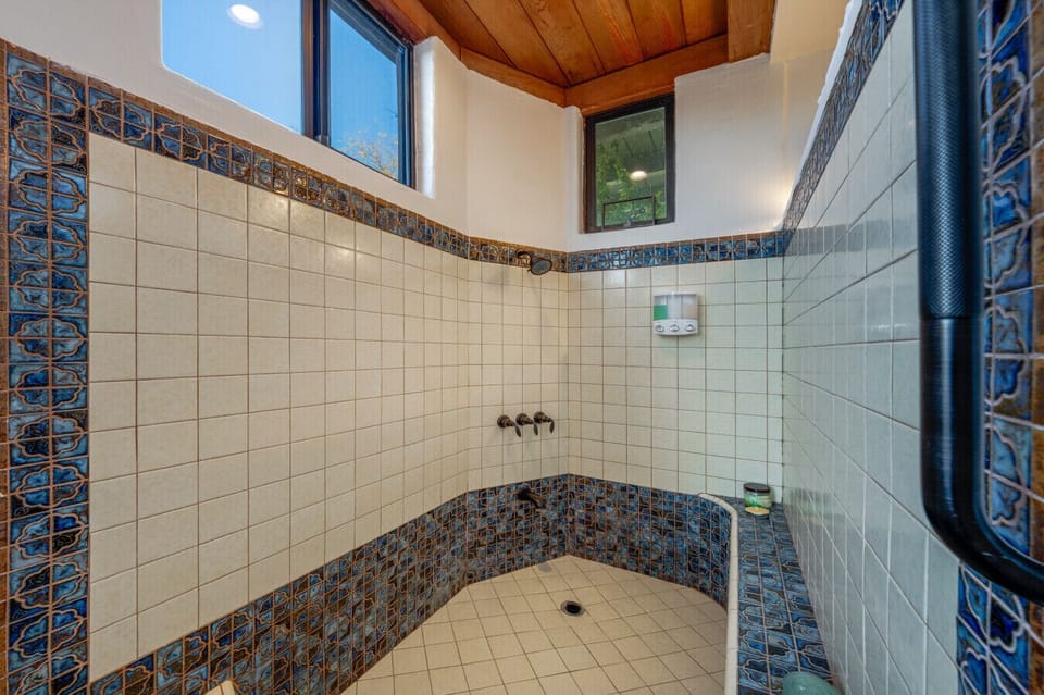Bathroom 1 with sunken tub/shower combo and lots of beautiful natural light