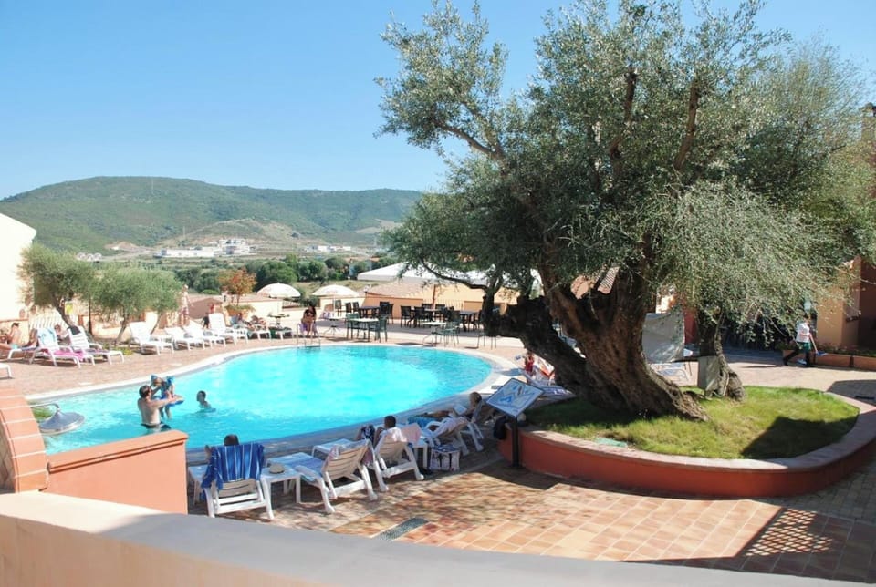Seasonal outdoor pool, open 9:00 AM to 7:00 PM, pool umbrellas
