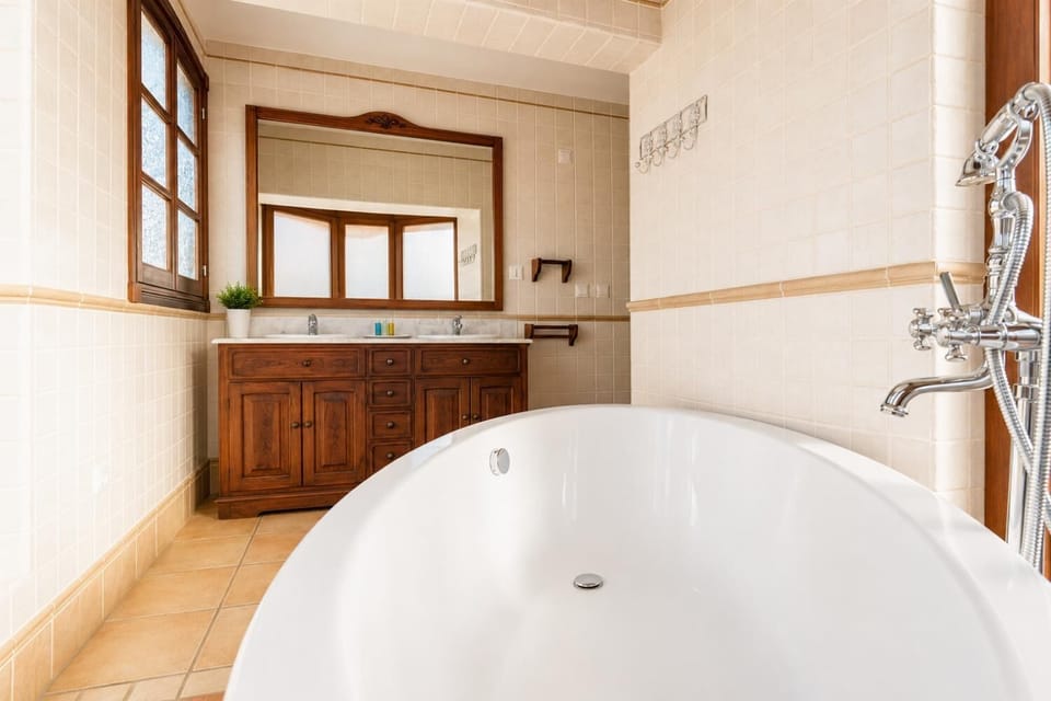 En suite bathroom with bath and shower