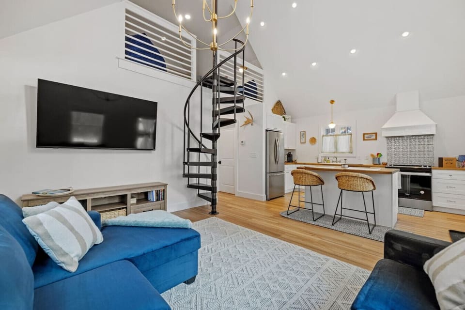 Bright, open living room with vaulted ceilings and cozy seating.