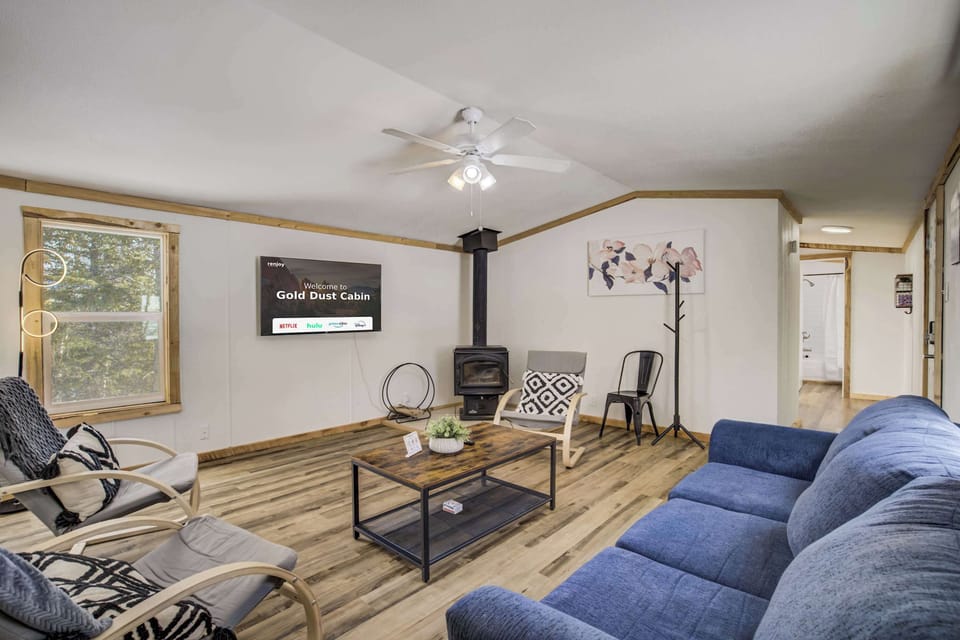 Unwind in the cozy living room featuring plush seating, a large Smart TV for movie nights, and peaceful forest views through the windows. 
Please note the indoor fireplace is not available for guest use at this time. We appreciate your understanding.