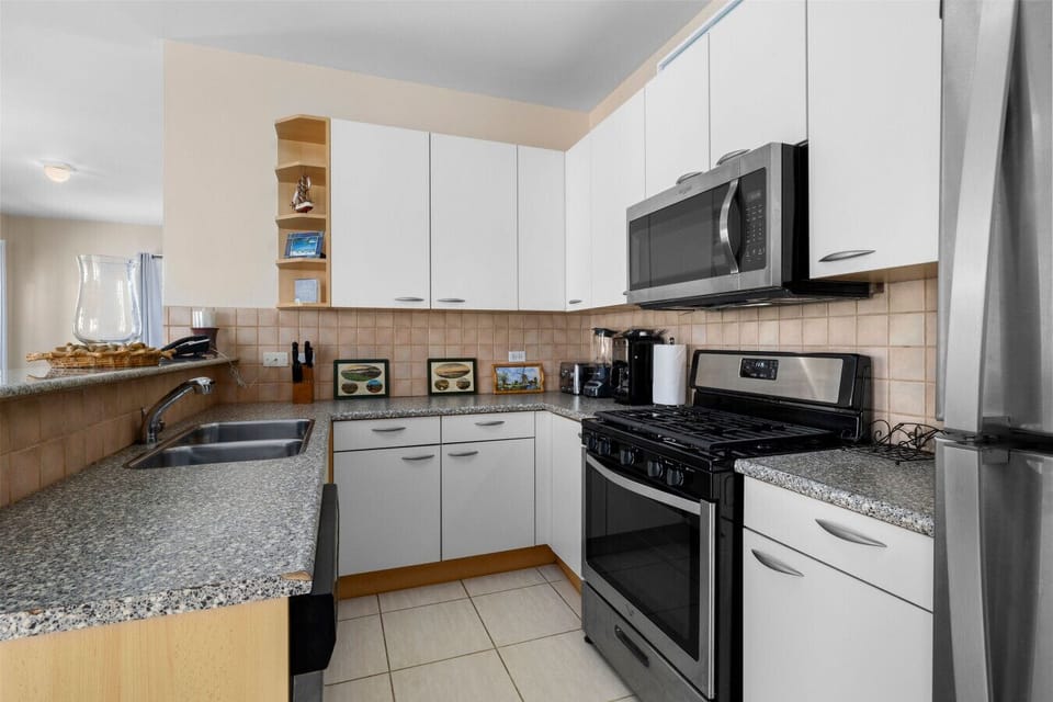 Cook and create in this modern kitchen, equipped with sleek appliances and ample space for culinary adventures during your stay!