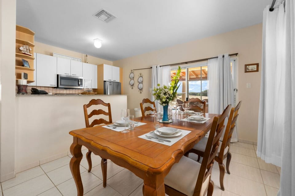 Savor delightful meals in this inviting dining area, featuring a charming table and beautiful views for a memorable experience!