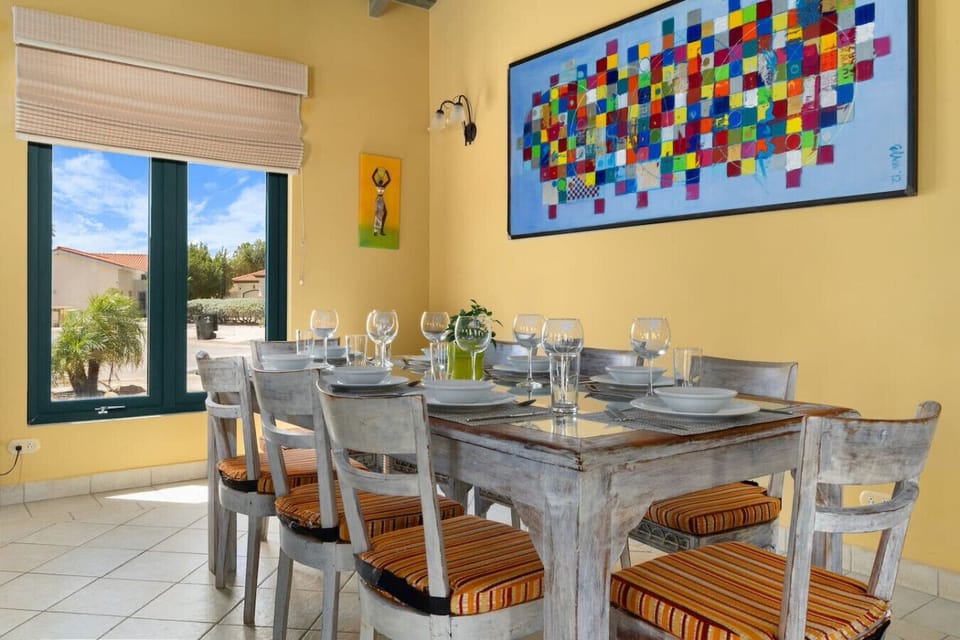 A bright and inviting dining area with a modern table, comfortable seating, and vibrant decor, perfect for enjoying meals and creating lasting memories.