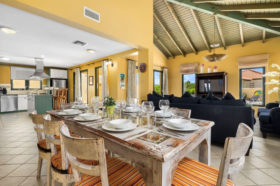 A stylish dining room with a modern table, comfortable seating, and elegant decor, offering a welcoming space for meals and gatherings with loved ones.